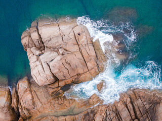Aerial view over rocks landscape and waves splash at Laem Krating, Nai Harn Beach, Phuket, Thailand