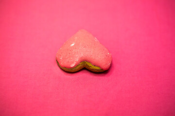 Heart-shaped biscuit. Pink background. Valentines day.