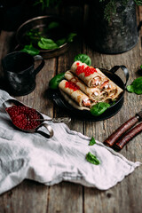 Pancakes with red caviar and salmon in a plate. Maslenitsa holiday