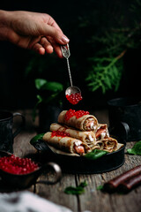 Pancakes with red caviar and salmon in a plate. Maslenitsa holiday