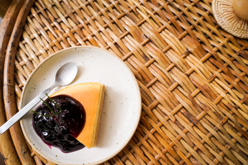 cheese cake in round plate on the Rattan table