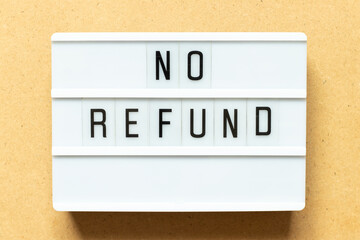 Lightbox with word no refund on wood background
