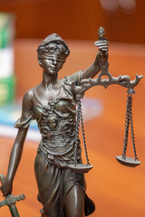 Scales of Justice, the symbol of a statue of blindfolded Themis, tools used to remain balanced and pragmatic. Goddess also has a sword. Court, human rights, advocacy, lawyering and education concept