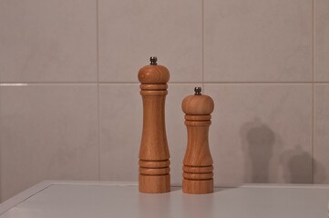 A wooden pepper mill and salt mill isolated in the kitchen (Pesaro, Marche, Italy)