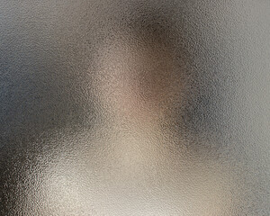 The silhouette of a man behind glass