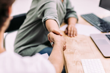 close up.the employer shaking hands with a new employee.