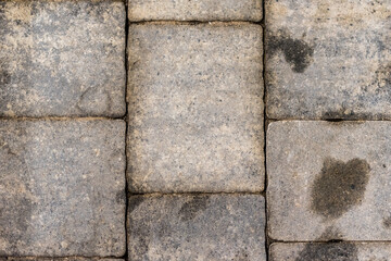 Oil stained cobblestones, rock structure and cubes close up.
