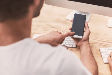 businessman uses his smartphone in the office