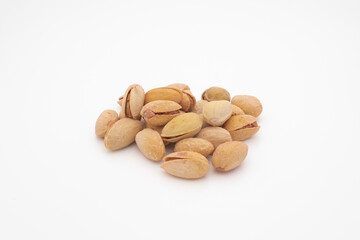 pile of salted pistachios isolated on white background