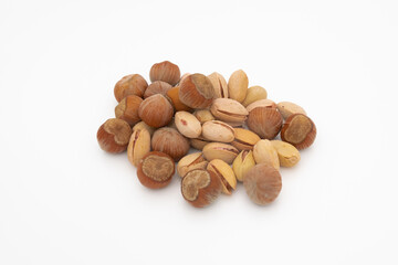assorted hazelnuts and pistachios in shell isolated on white background