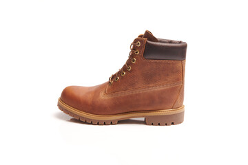 Mens leather brown waterproof boots for winter or autumn hiking isolated on white background. Mens fashion, trendy footwear. Close up view.