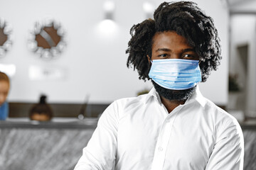 African american man in white shirt wearing medical face mask