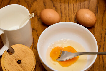 Eggs on a table, a salt shaker and a bowl