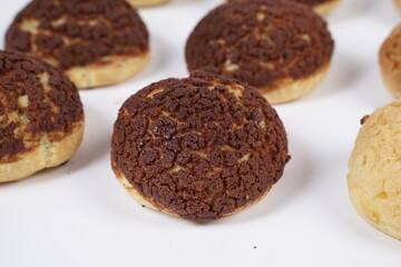 French traditional Choux pastry ball. Choux with  filling chantilly cream. Fresh golden profiterole or Pate a choux. Selective focus. Cream Puffs, choco vanilla Choux isolated on white background. 
