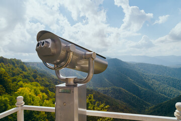 Coin Operator Binocular viewer Landscape with a beautiful cloudy sky and mountains ..