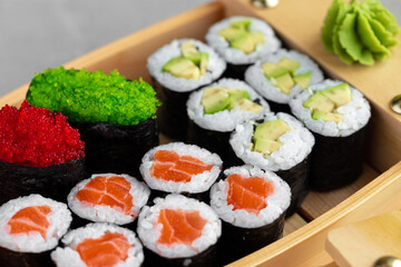 Set of maki sushi on wooden boat tray