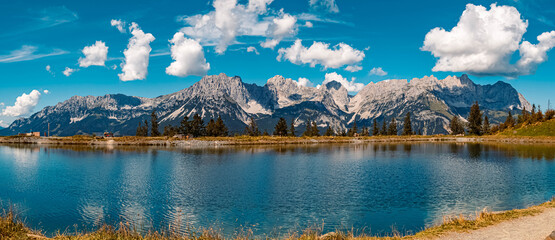 High resolution stitched panorama of a beautiful alpine summer view with reflections in a lake at...
