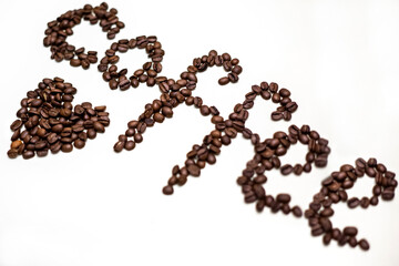 Word coffee written in grains. White background.