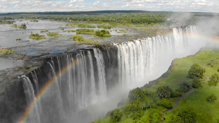 Luftaufnahme der Viktoriafälle in Sambia und Simbabwe mit dem Sambesi Fluss und einem Regenbogen