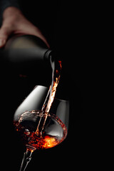 Fototapeta na wymiar Pouring brandy in a glass goblet.