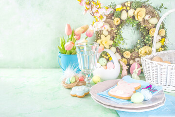 Fototapeta na wymiar Happy Easter concept with easter eggs in basket and spring flowers. Easter background with copy space and photo frame. Happy Easter greeting card background