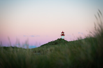 Naklejka na ściany i meble Lighthouse on Sylt island Germany during colorful cloudless sunset no. 2