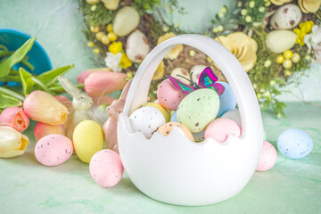 Fototapeta na wymiar Happy Easter concept with easter eggs in basket and spring flowers. Easter background with copy space and photo frame. Happy Easter greeting card background