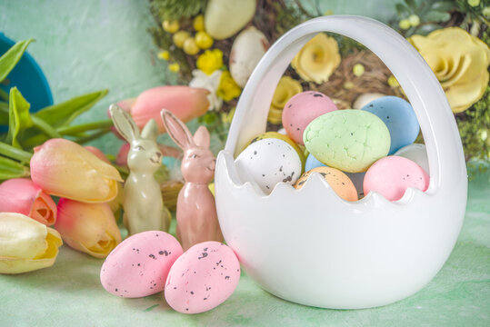 Happy Easter concept with easter eggs in basket and spring flowers. Easter background with copy space and photo frame. Happy Easter  greeting card background