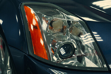 close-up of front xenon turning headlights of modern car in garage