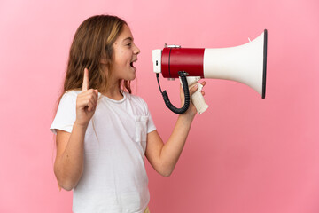 Child over isolated pink background shouting through a megaphone to announce something in lateral...