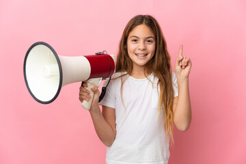Child over isolated pink background holding a megaphone and pointing up a great idea