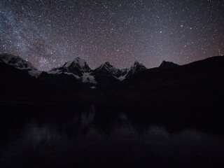Night sky milky way stars at Cordillera Huayhuash Circuit andes alpine mountain lake Laguna...