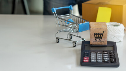Online merchandise boxes on table, blurred background with boxes and pens