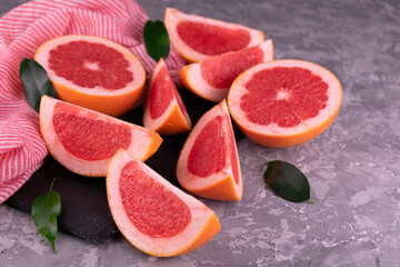 Sliced ​​grapefruit on a gray background.