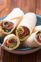 Sliced sandwich tortilla with vegetables and ham