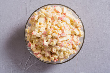 Salad with crab sticks , corn , eggs and mayonnaise