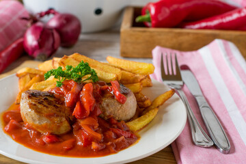 pan fried pork fillet medallions with homemade french fries and spicy pusta sauce