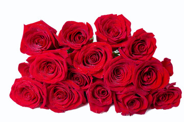 Obraz premium Bouquet of red (burgundy) roses on a white background. Water drops. Close-up.