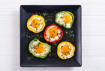Yellow , red and green pepper with fried eggs