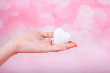Heart in hand on pink background with bohe. Greeting Valentine's day card