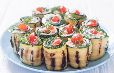 Zucchini rolls with cream cheese , tomatoes and dill