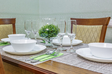 served table with a bouquet of roses in interior of modern luxure guest room in studio apartments in minimalistic style