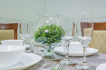 served table with a bouquet of roses in interior of modern luxure guest room in studio apartments in minimalistic style