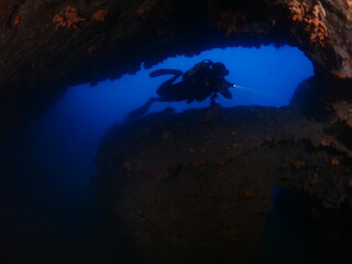 cave diving underwater scuba divers exploring caves and having fun ocean scenery sun beams and rays background