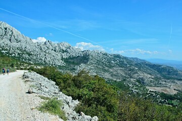 Croatia-view of the tourists and rocky city of Tulove Grede in the Velebit National Park