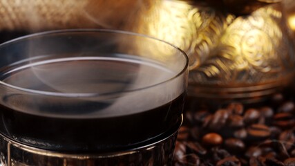 Turkish coffee in traditional glass cup.