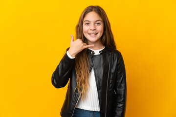 Child over isolated yellow background making phone gesture. Call me back sign