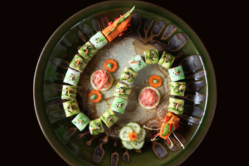 Sushi in a form of dragon on big plate
