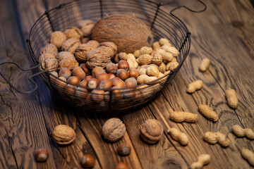 still life with hazelnut peanuts walnut and coconut on wooden board