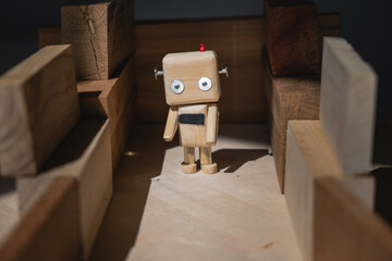 a small wooden robot in a maze of wooden blocks is at a dead end.